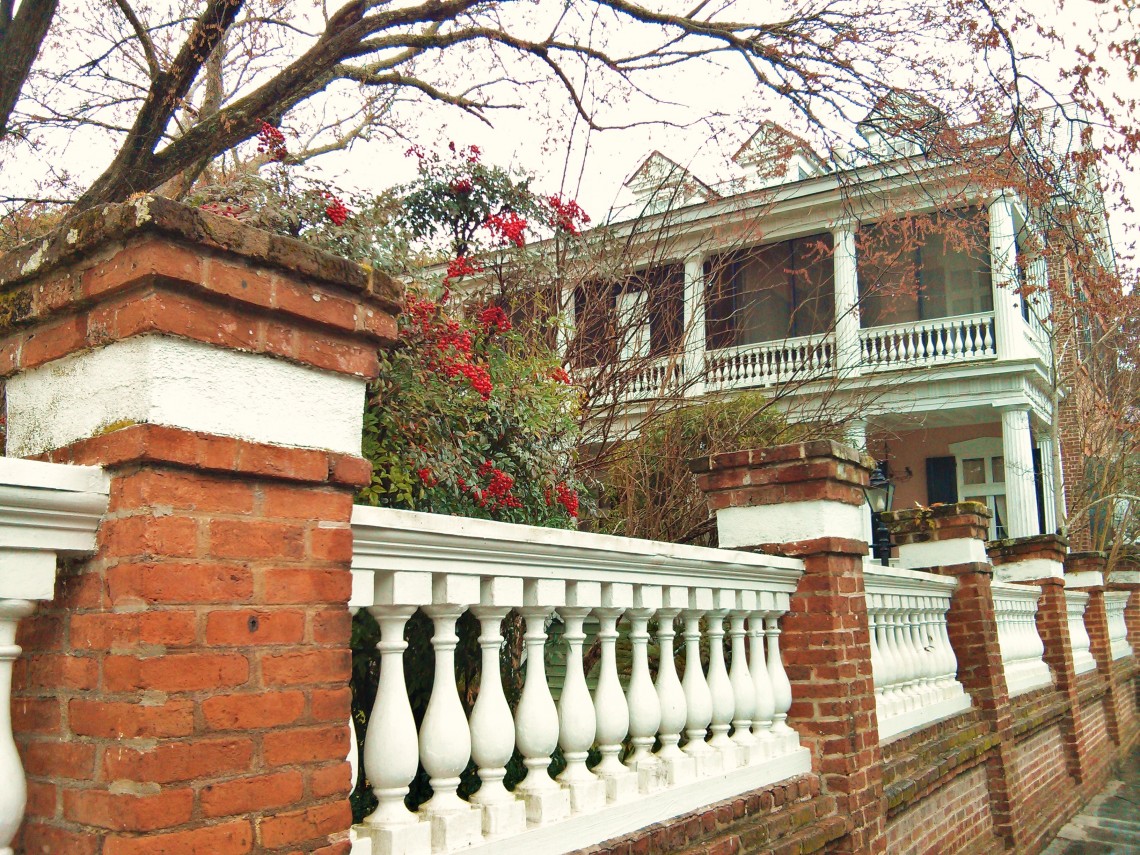 Berries brighten up an 1850's Charleston house and wall on a winter day