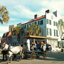 A classic scene of visitors taking a carriage tour in Charleston, SC