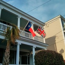 These flying flags, glowing in the late afternoon sun, can be found on Tradd Street in Charleston, SC.