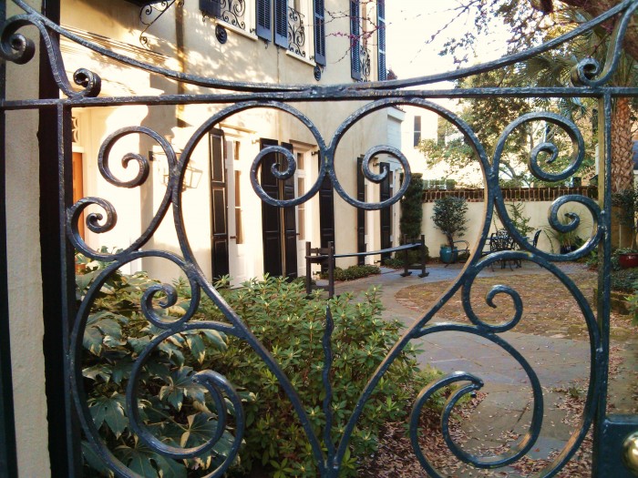 So much of what screams Charleston is here -- beautiful house and garden, joggling board and a beautiful iron gate.