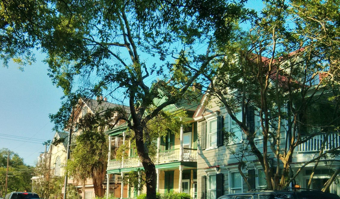 The evening light making a row of beautiful Charleston, SC houses glow.