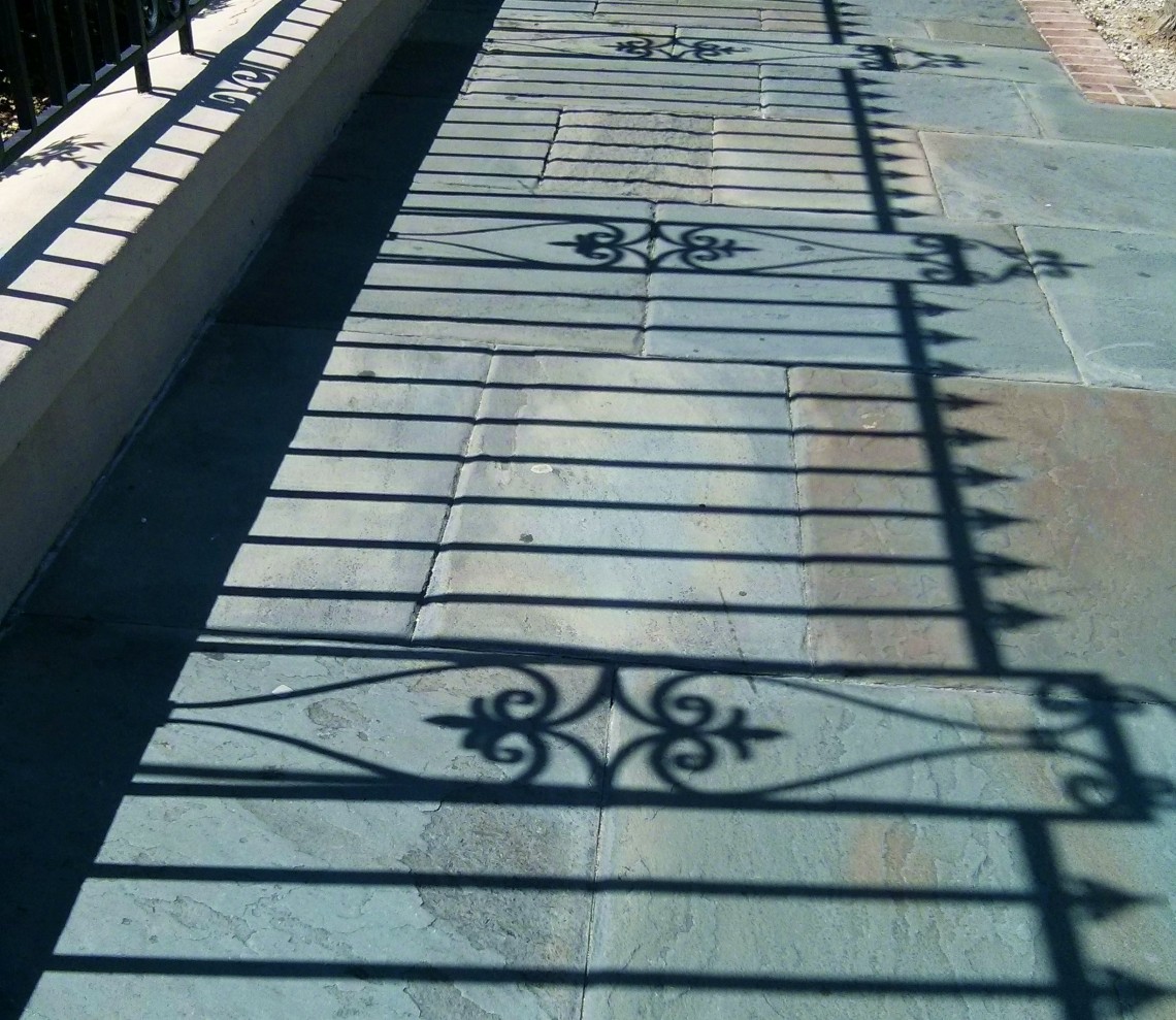 The amazing Charleston ironwork casts amazing shadows. Project them on a blue stone sidewalk and it is a quintessential Charleston image.