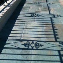 The amazing Charleston ironwork casts amazing shadows. Project them on a blue stone sidewalk and it is a quintessential Charleston image.