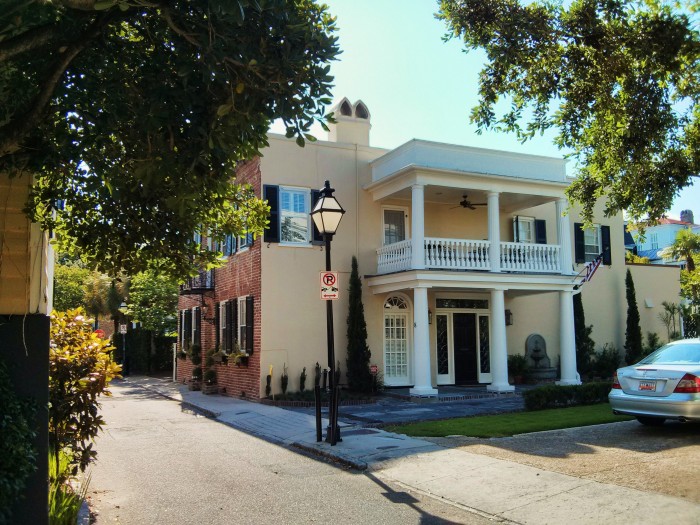 The beauty of Charleston, SC architecture takes many forms. Here there is an unusual combination of brick, stucco and a side portico.