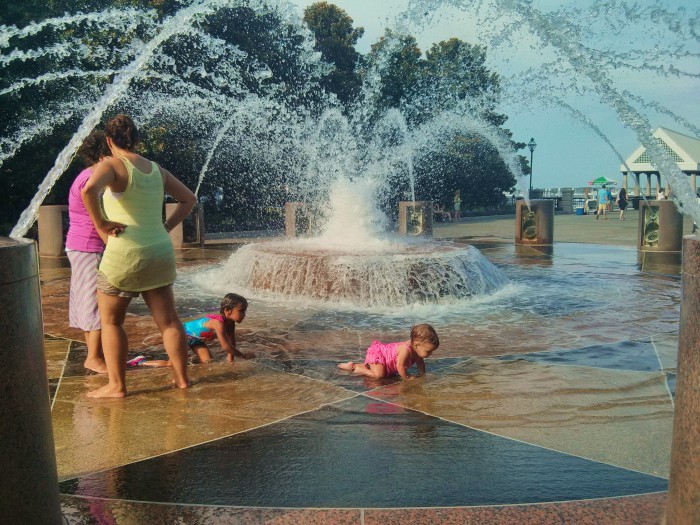 In hot summer weather in Charleston, SC cooling off in the fountains in Waterfront Park is the thing to do... especially with a friend.
