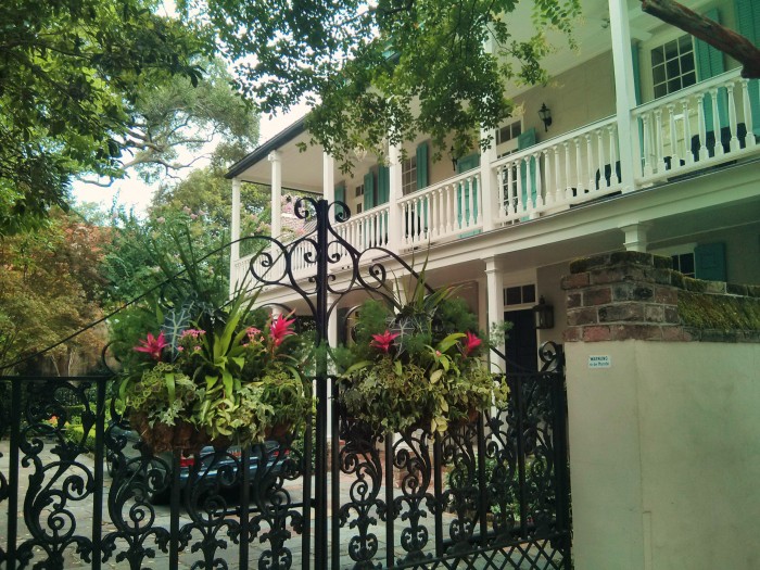 These beautiful flower baskets, iron gate and piazza can be found on lower King Street in Charleston, SC.