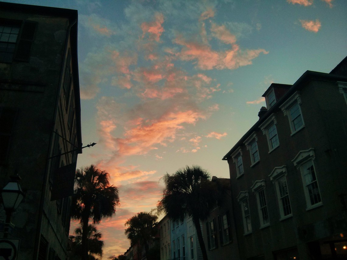 The setting sun reflecting off some clouds over the pre-colonial streets of Charleston, SC.