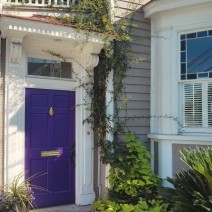 This purple accented house (including a bumble bee above the address) is located on Spring Street in Charleston, SC.