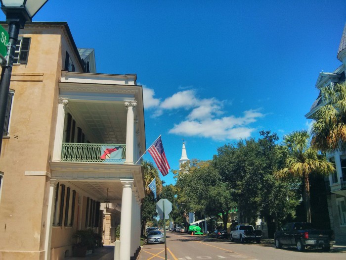 A beautiful view up Meeting Street in Charleston, SC contains one of the few houses with a portico and the St. Michael's church steeple.
