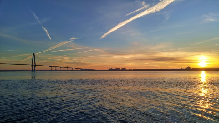 The sun rising over Charleston Harbor, illuminating the wonderful Cooper River Bridge.