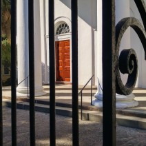 The iron fence outside the First Baptist Church in Charleston, SC provides for a beautiful frame for its impressive doors and columns.