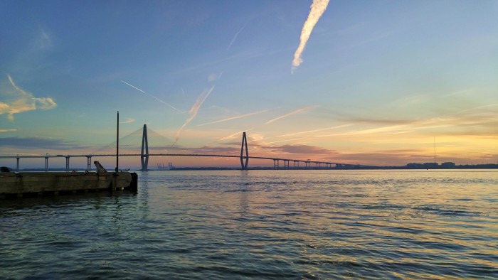 The early morning sun over Charleston Harbor illuminates the Ravenel (Cooper River) Bridge.