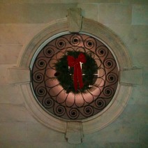 A wreath is beautifully framed by one of the "ports" in Charleston City Hall.