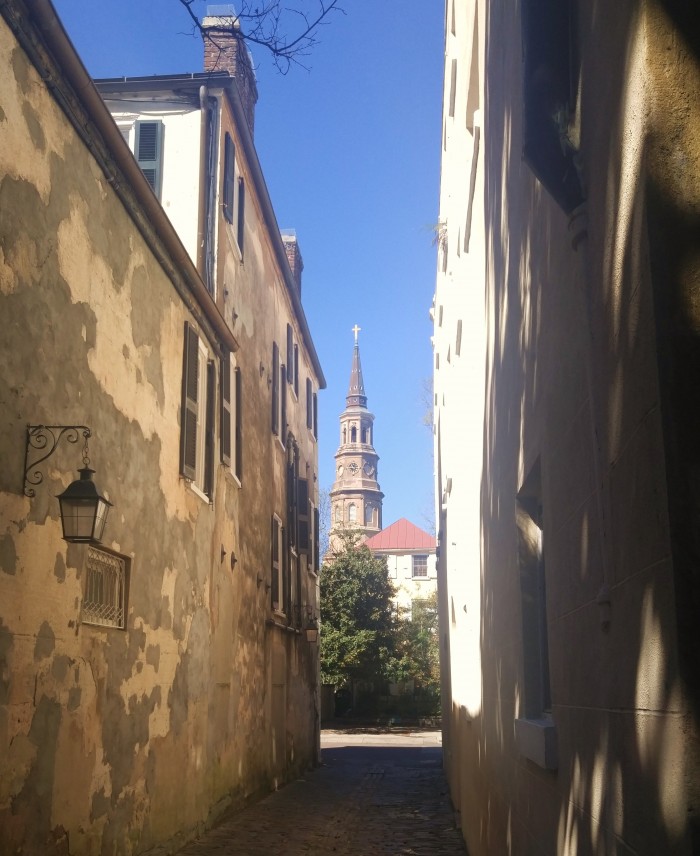 A beautiful view of St. Philip's Church from the cobblestoned Lodge Alley in Charleston, SC.
