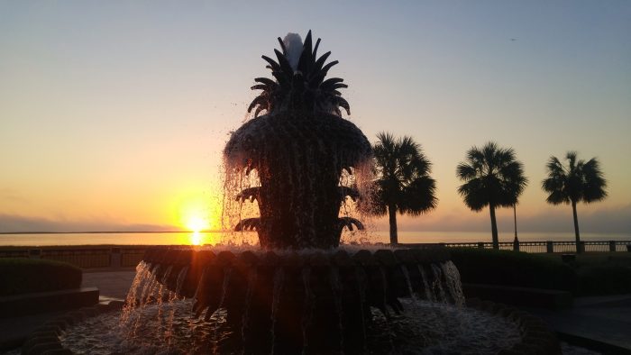 The sun coming up behind the Pineapple Fountain in Waterfront Park. in Charleston, SC.