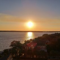 The end of month sun reflecting on the Ashley River in Charleston, SC as it starts to set.