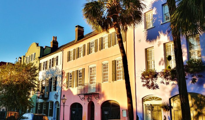 The early morning sun lights up some of the attached antebellum homes that make up Charleston's famous Rainbow Row.
