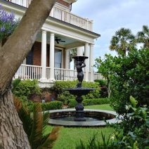 This wonderful Charleston garden is at the very first house built on Murray Boulevard. The ceiling of the porch is painted in "Haint Blue." The Gullah-Geechee communities, found in coastal South Carolina and Georgia, believed that the blue would keep the spirits of the dead (the haints) from entering the house. Now common in Charleston and across the South, it may or may not work on the spirits, but it sure does make for a pretty porch.