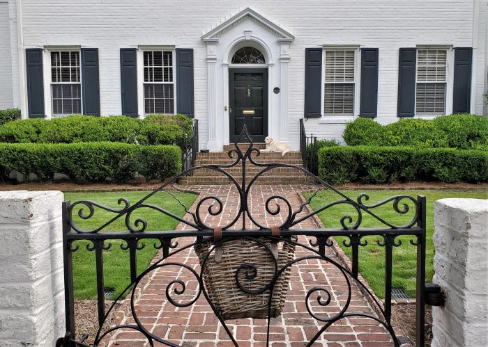 This handsome house, built in 1929 on reclaimed land on South Battery, is picture perfect with its gold guardian.