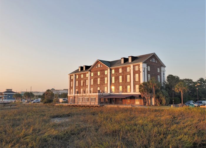 The setting sun reflecting on the historic Rice Mill, located off Lockwood Boulevard along the Ashley River.