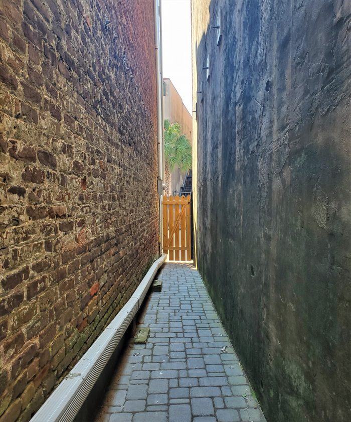 Between downtown buildings you can often find a tight squeeze of an access path. If you exited this one and turned left, you would be walking down King Street -- right past the wonderful old cinema, the American Theater, which was appeared on the other side of the screen in the film The Notebook.