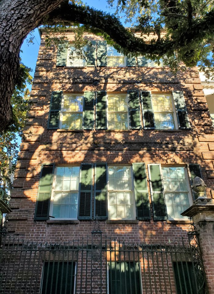 A sun dappled late afternoon view of the street side of the famous Pineapple Gates House, aka the Simmons-Edwards House, on Legare Street.