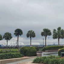 A view across Joe Riley Waterfront Park. In the distance you can see the WWII aircraft carrier the USS Yorktown, a storied fighting ship.