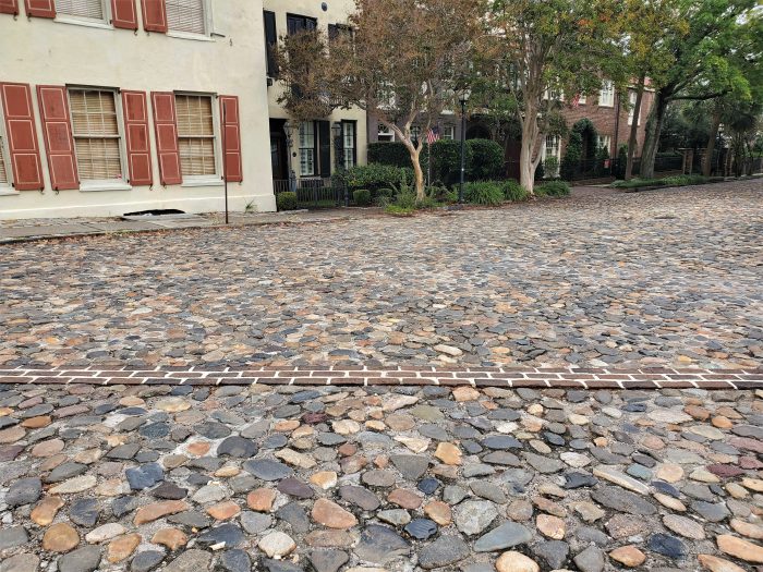 Charleston is one of the few cities in North America to ever have been a walled city. In the early 1700's, the wall protected the residents from everything from pirates to the Spaniards and French. While the wall has been mapped, there are only a few spots where you can actually see its remnants. The brick line here, across the cobbles of North Adgers Wharf, represents where the wall crossed at that point -- and if you dig down you will find it (but do not do that without permission and proper archaeological processes!)