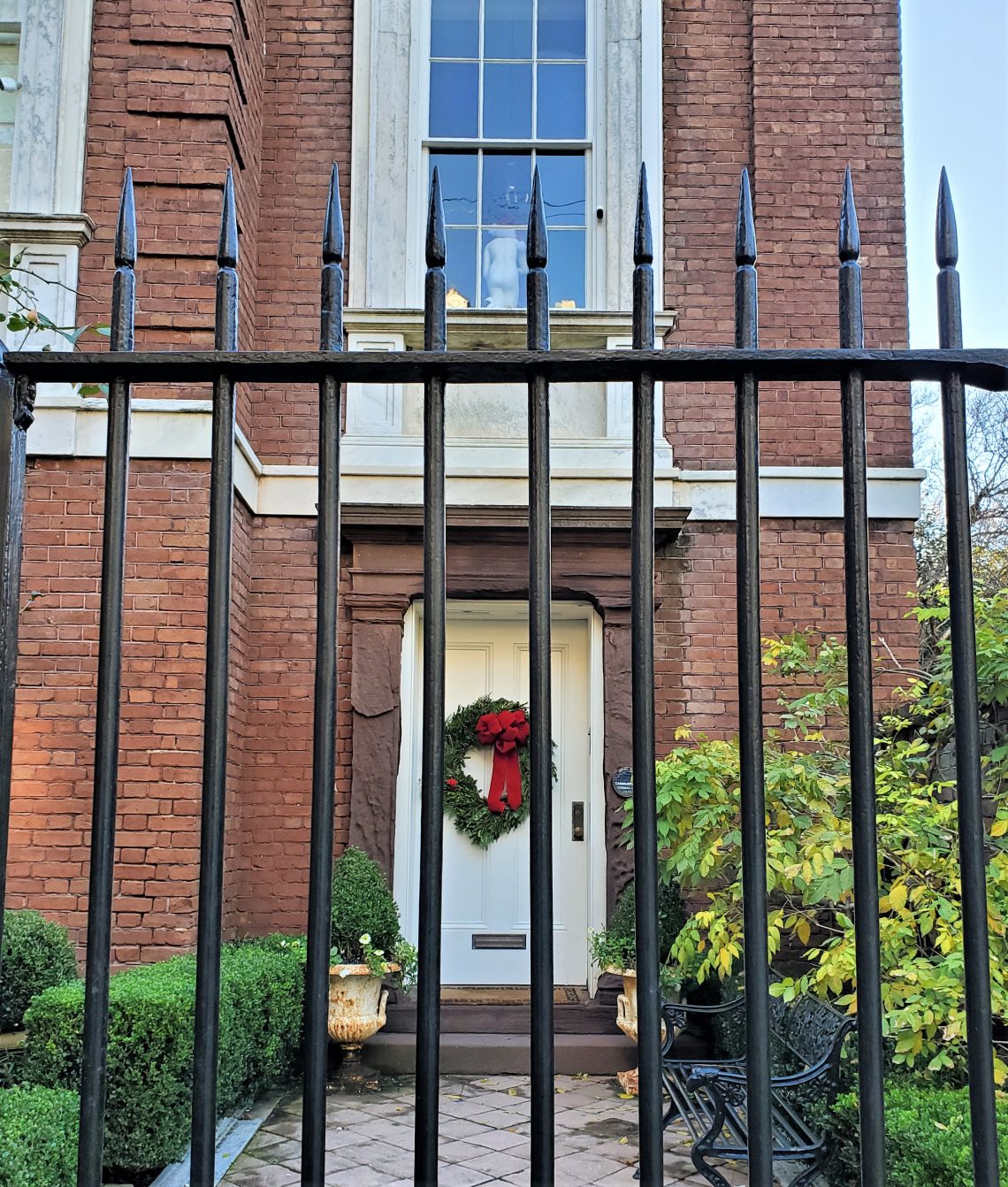 The rear of the statue in the second floor window of this imposing house on Legare Street always catches my eye, even when the house is decorated for the holidays. I often wonder if this view is intentional.