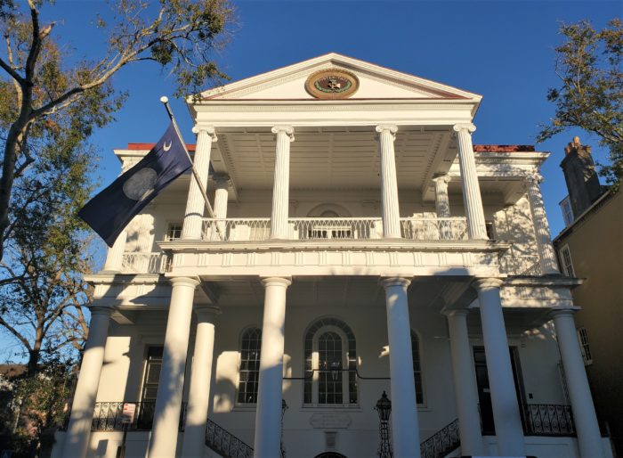 South Carolina Society Hall was originally created to be a meeting place and a school for indigent children. Built on Meeting Street in 1803-04, it has had several modifications and renovations over the years -- a significant one took place after the Civil War, in which the building sustained damage during the bombardment of Charleston. It is said that there are still cannonballs lodged in the trusses in the attic.