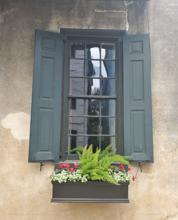 The house to which this handsome window and flower box belong is on Tradd Street and dates back to 1740. It was the home of the 5th postmaster of Charleston. And in keeping with the tradition of the time, the front room of the house was used as the post office. 