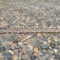 This line of bricks represents where the wall (more specifically, a "redan") of the original walled city of Charleston once was. It was identified during an archaeological dig by the "Walled City Task Force." You can find it along the top of South Adger's Wharf and through the adjacent parking lot. Pretty cool.
